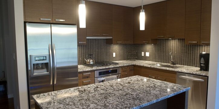 Modern luxury kitchen featuring granite counter tops and stainless steel appliances