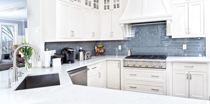 Modern Kitchen Design with Stainless Appliance A contemporary home kitchen with stainless steel appliances and painted white cabinets.